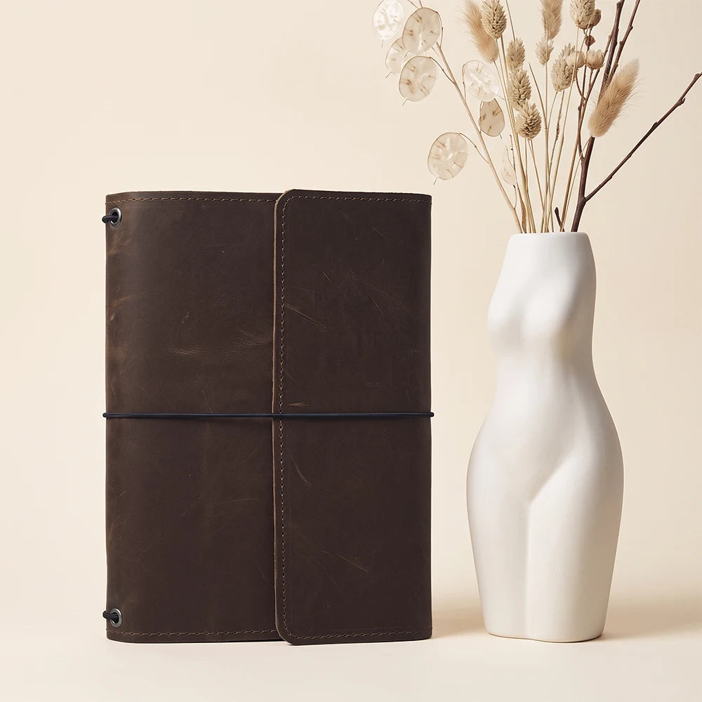 Premium refillable leather journal cover featuring handcrafted details and functional interior organization.