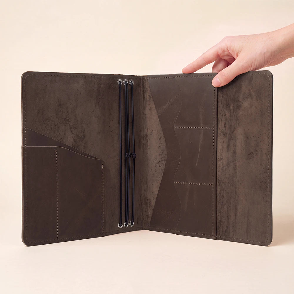 Premium leather notebook case offering elastic insert holders and spacious inside organization pockets.