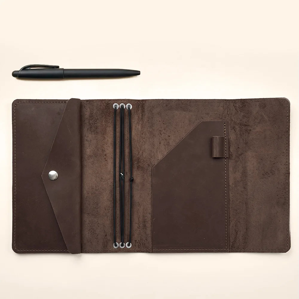 Rustic leather journal cover offering refillable functionality and organized storage for essential accessories.