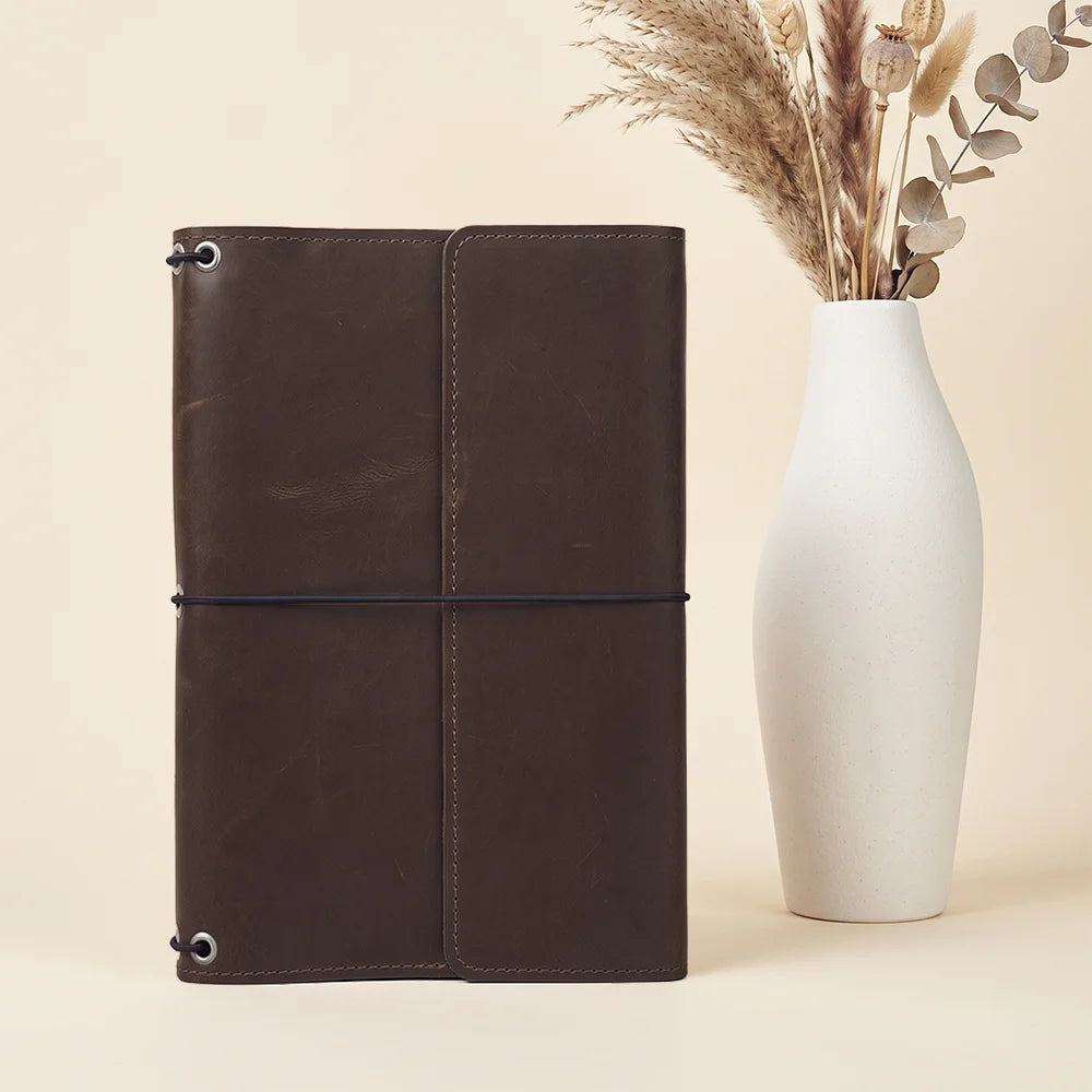 Elegant leather notebook cover offering handcrafted quality with convenient interior organizer pockets.