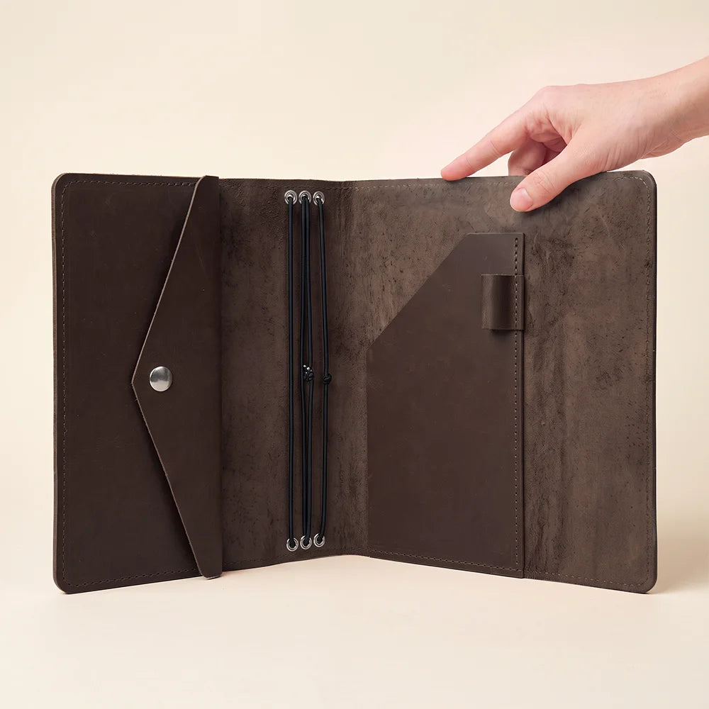 Leather travel notebook holder built for planners, journals, sketches, and personal organization.