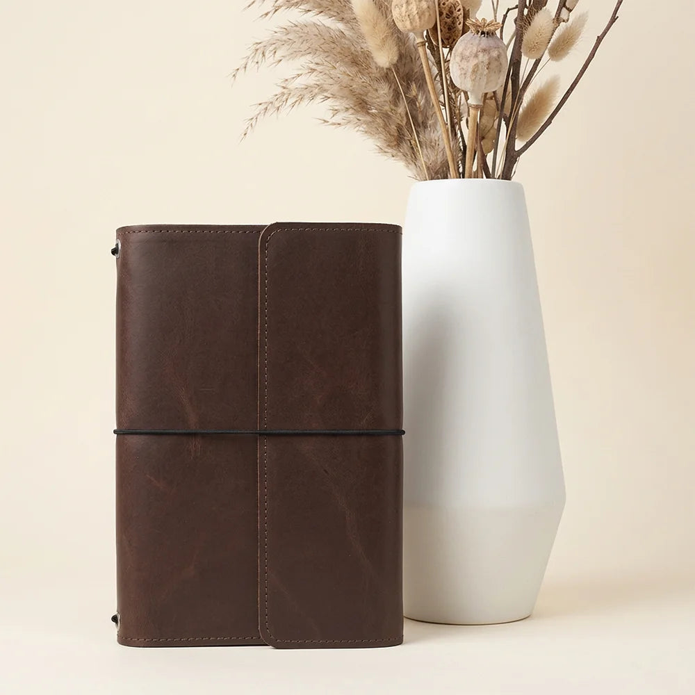 Artisan leather journal case showing functional interior storage areas alongside a convenient pen sleeve.