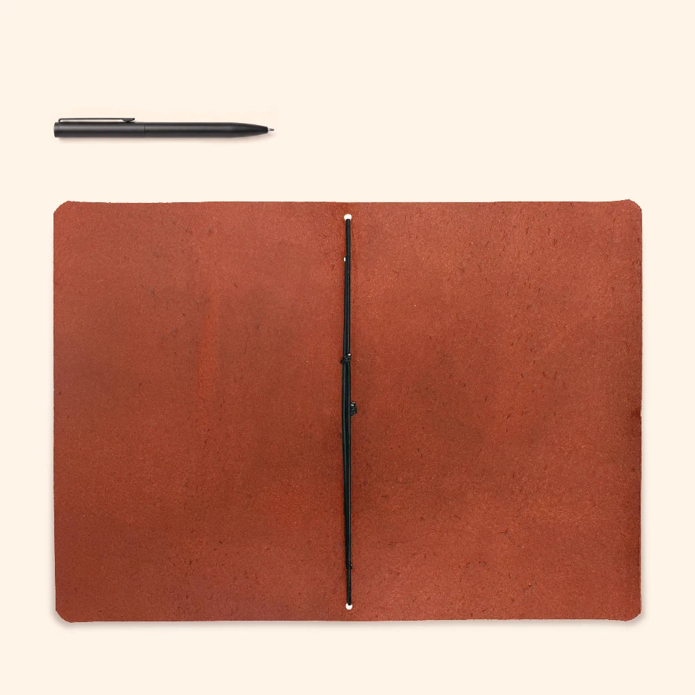 Natural leather notebook cover combining classic materials with a simple modern layout.