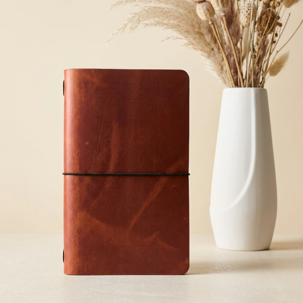 Genuine leather journal sleeve featuring a clean silhouette and one notebook securing band
