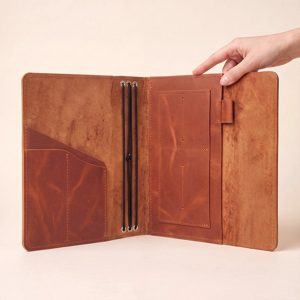 Leather notebook organizer with versatile storage compartments and integrated pen retention loop.