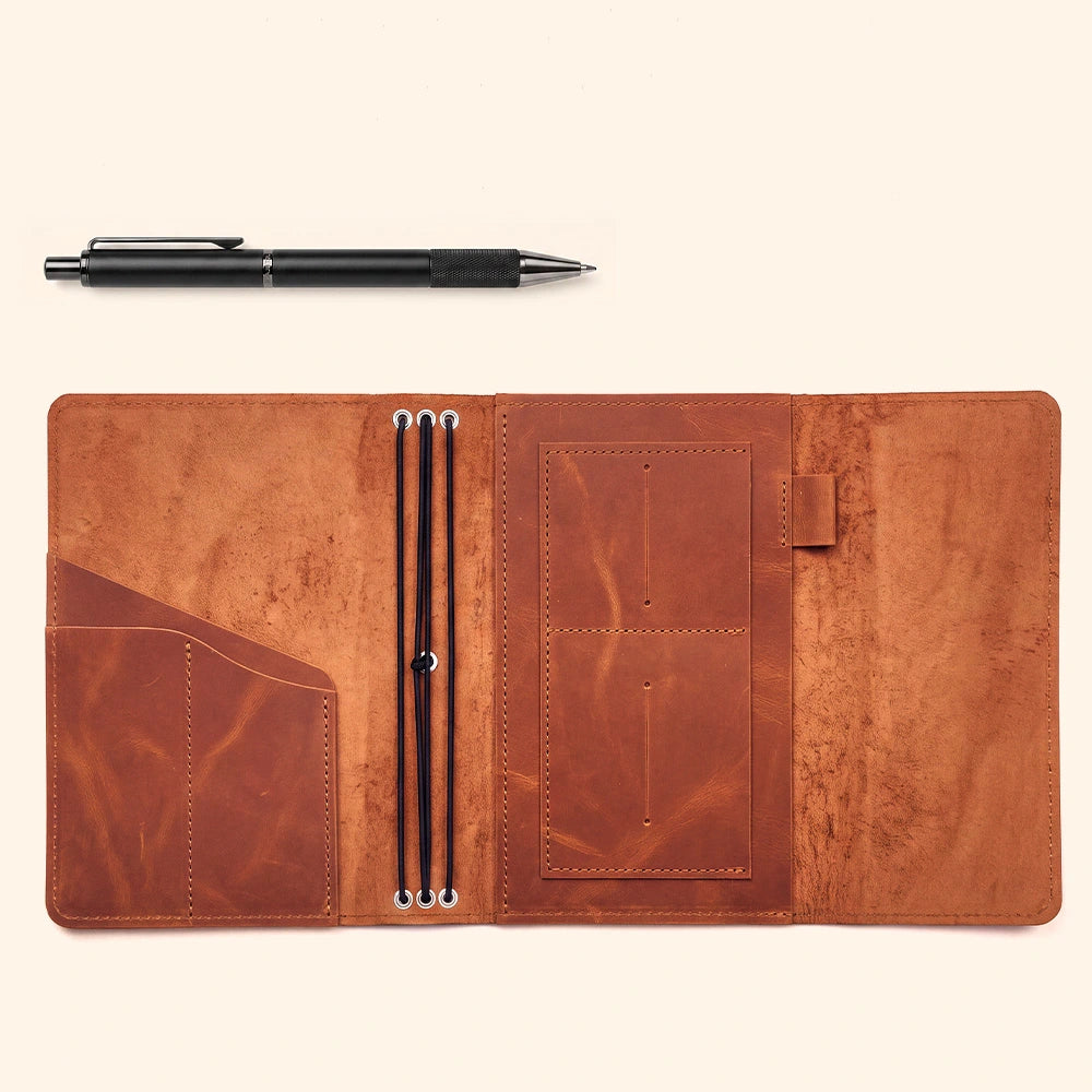 Genuine leather notebook cover with interior pockets and convenient pen loop for everyday journaling.
