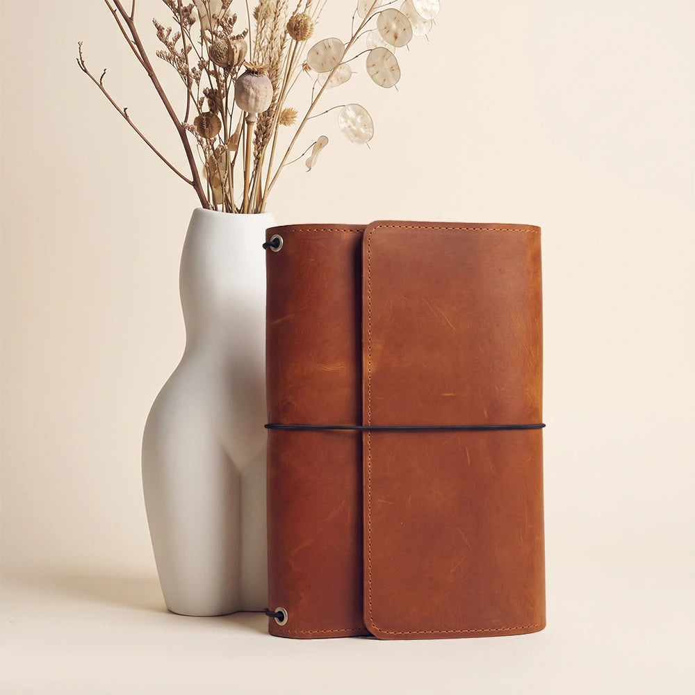 Leather notebook organizer with document pockets and integrated leather writing instrument loop