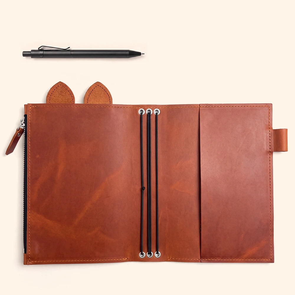Refillable notebook organizer crafted with durable leather and flexible elastic retention bands.