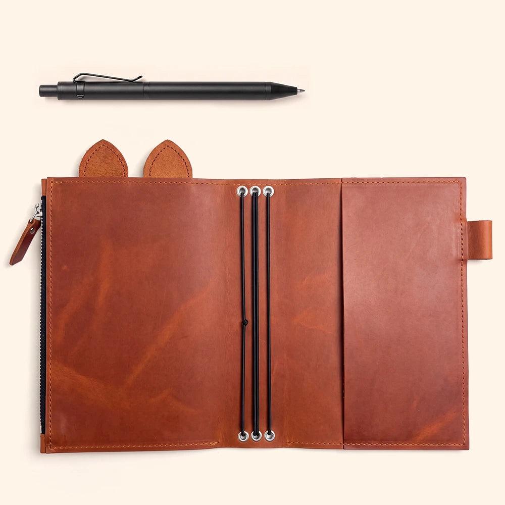Handmade leather notebook cover featuring large zipper pocket, pen holder, cute ears, and three elastics.