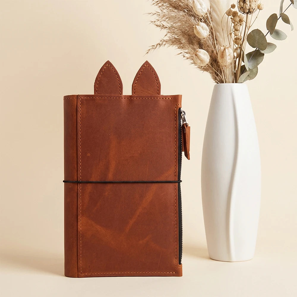 Handcrafted journal cover featuring a pen loop and charming leather ear-shaped tabs.