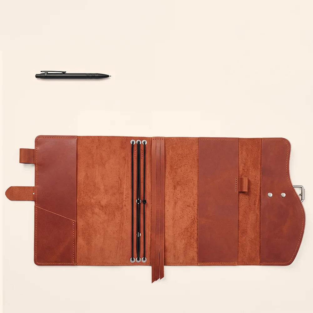 Leather journal sleeve with practical compartments, pen loop, sewn page marker, and convenient external grip.