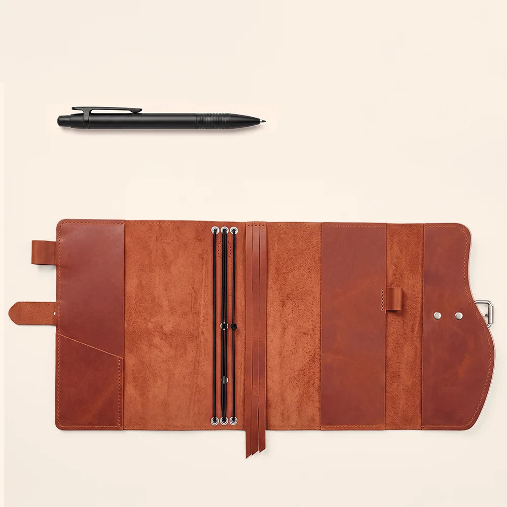 Genuine leather notebook cover with interior pockets, pen loop, bookmark, and convenient carrying handle.