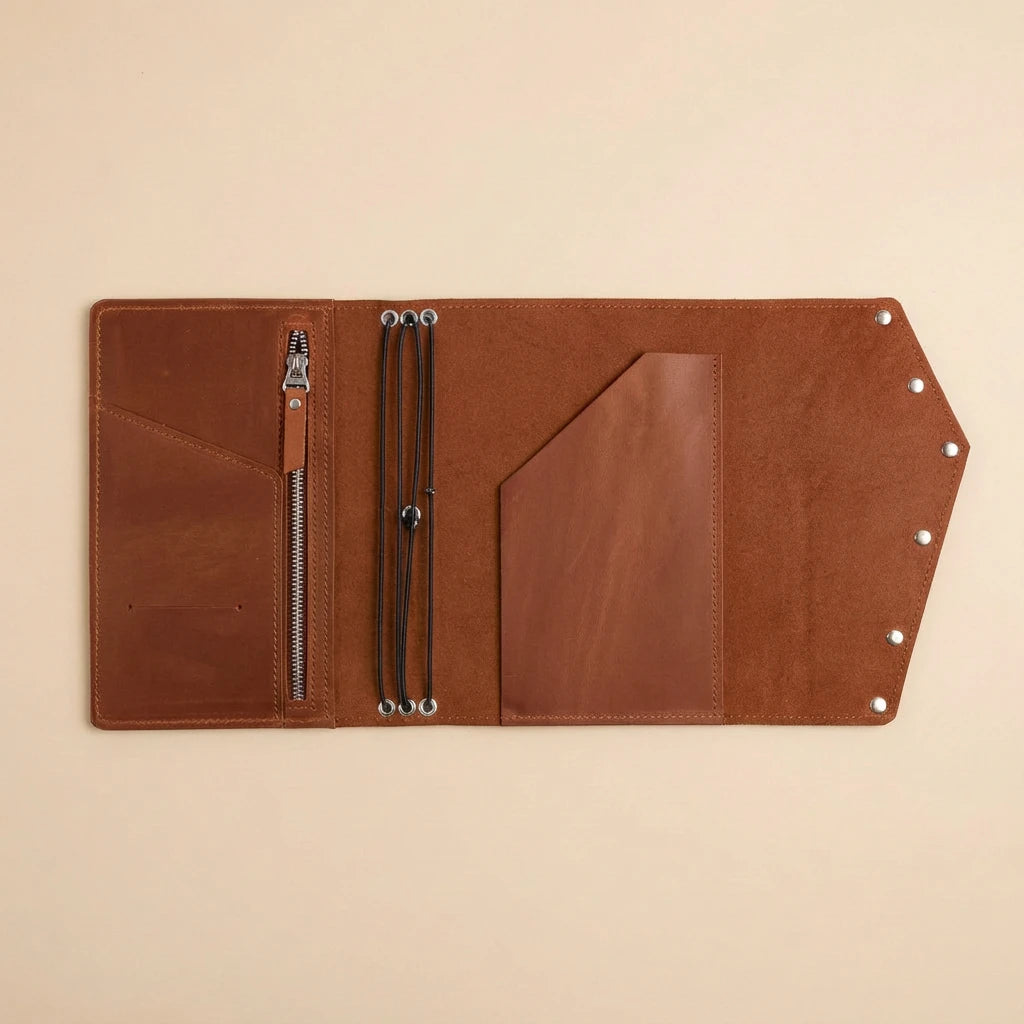 Brown leather journal with zipper on a beige background
