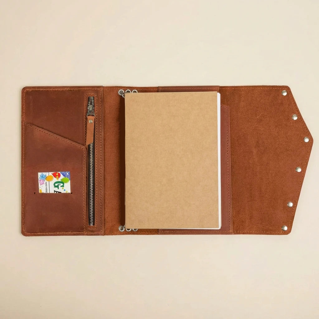 Brown leather journal with card holder on a beige background