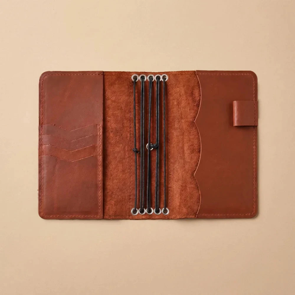 Custom leather journal cover with internal pockets and pen holder.