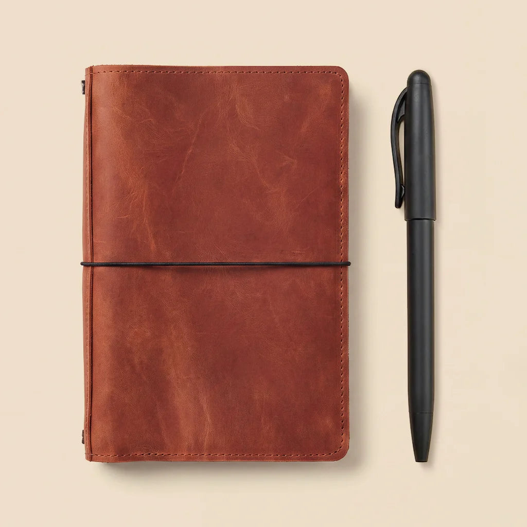 Genuine leather notebook cover with handcrafted details, interior pockets, and elastic insert bands.