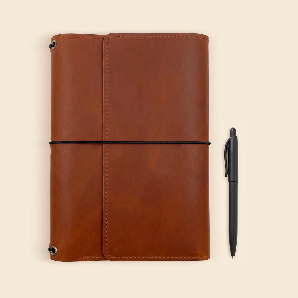 Premium leather notebook sleeve with refillable inserts and dedicated storage for a favorite pen.