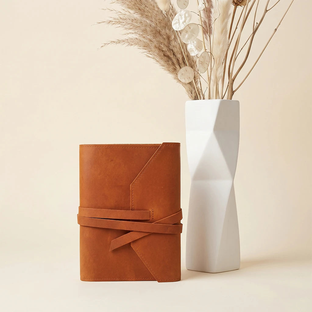 Genuine leather notebook cover with elastic bands and built-in pen holder.