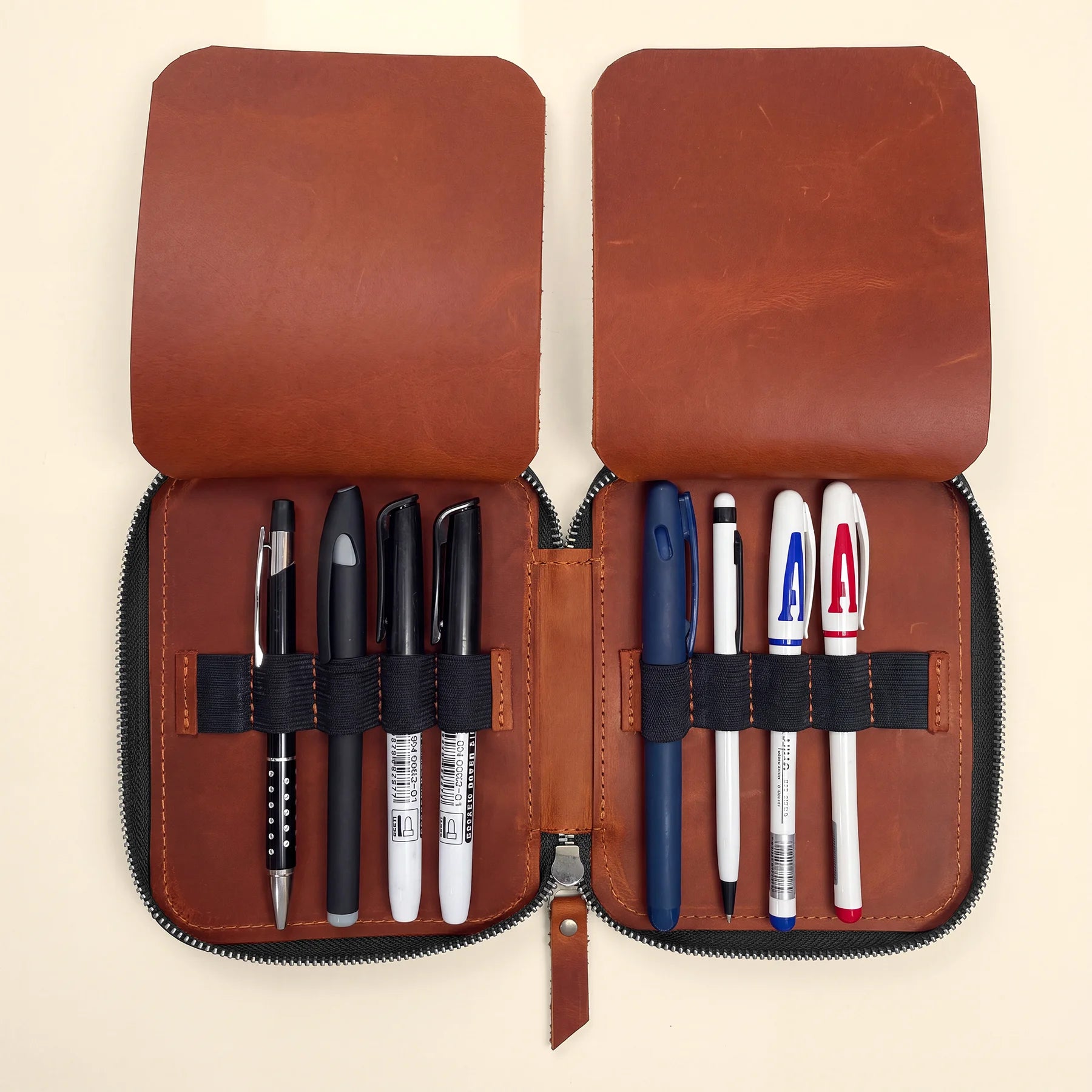 Handmade genuine leather pen case with zipper closure for everyday writing essentials.
