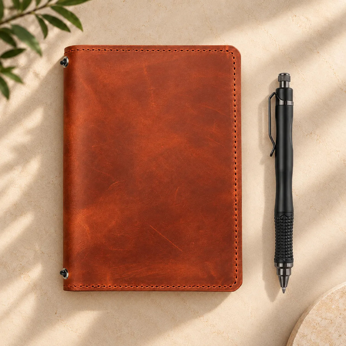 Genuine leather notebook cover with two elastic straps and convenient internal storage pockets.