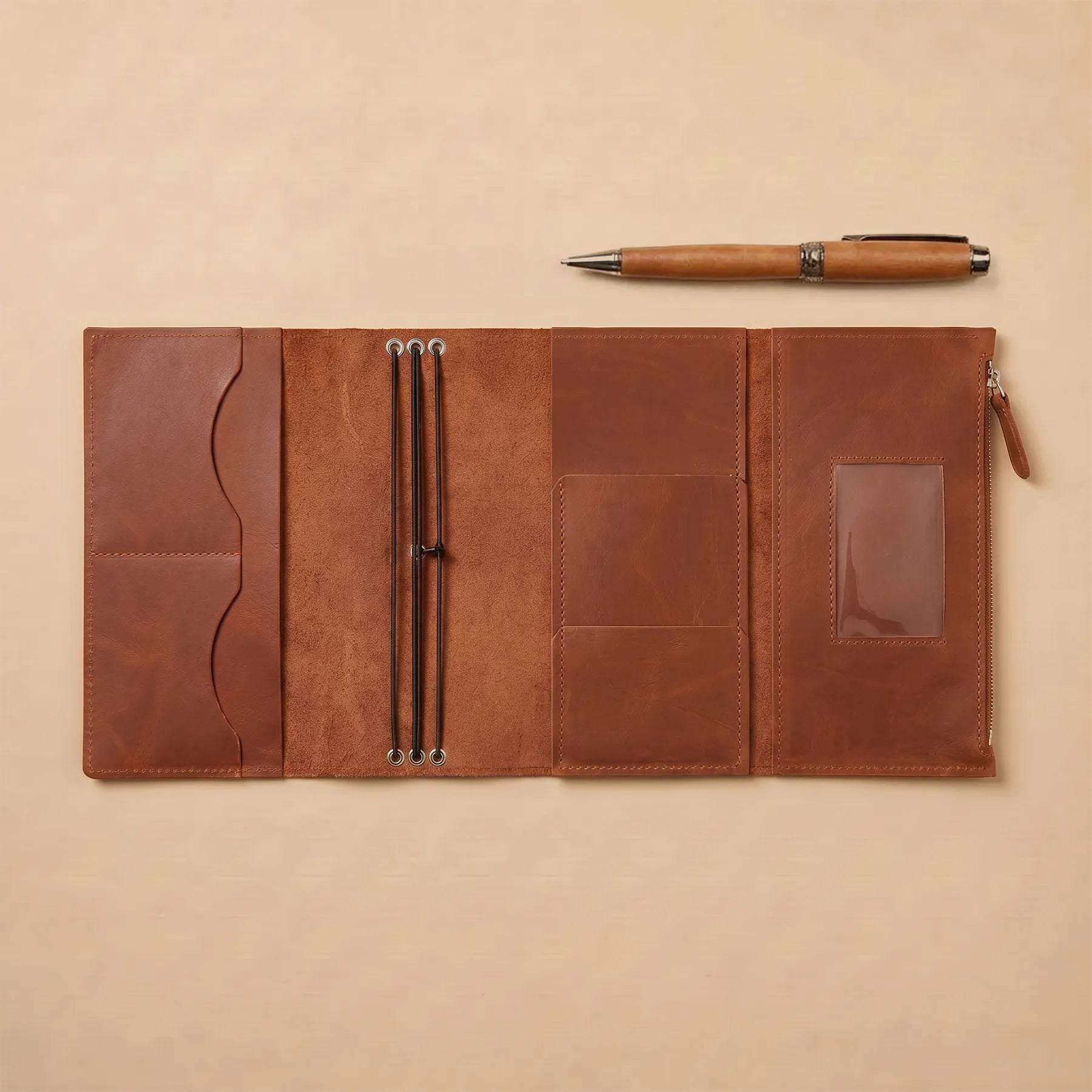 Genuine leather notebook cover with elastic closure and refillable insert system.