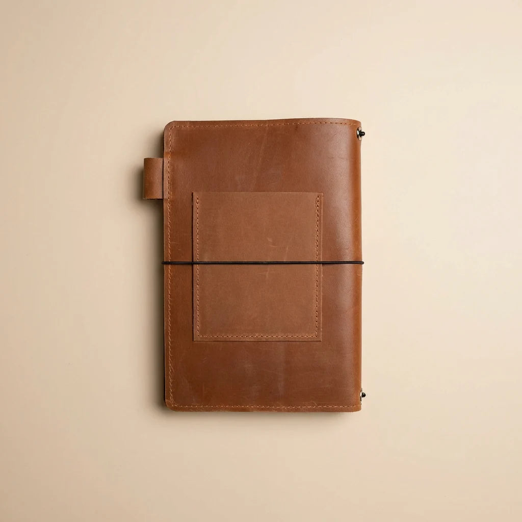 Brown leather notebook on a beige background