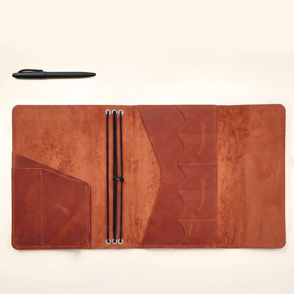 Genuine leather planner cover with organized pockets and refillable notebook insert compatibility.