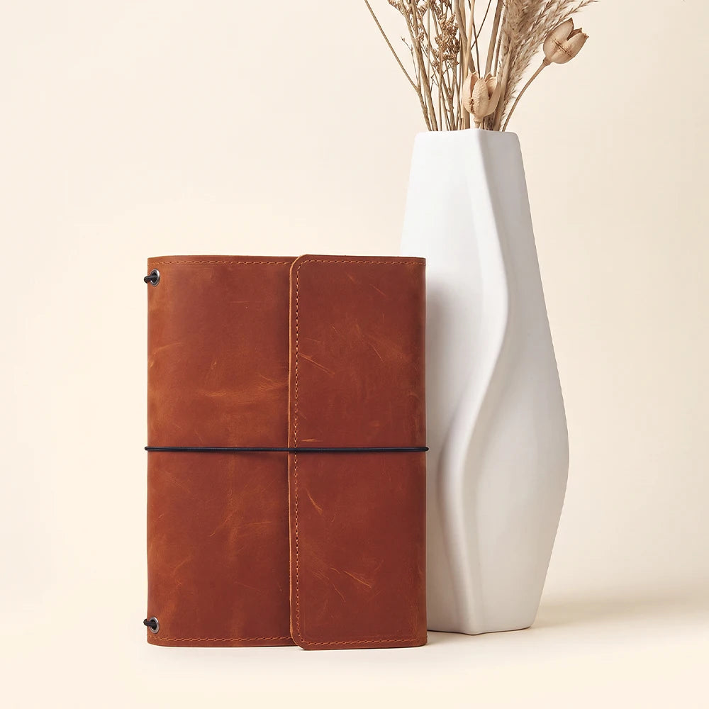 Genuine leather notebook cover offering flexible storage and durable elastic insert organization system.