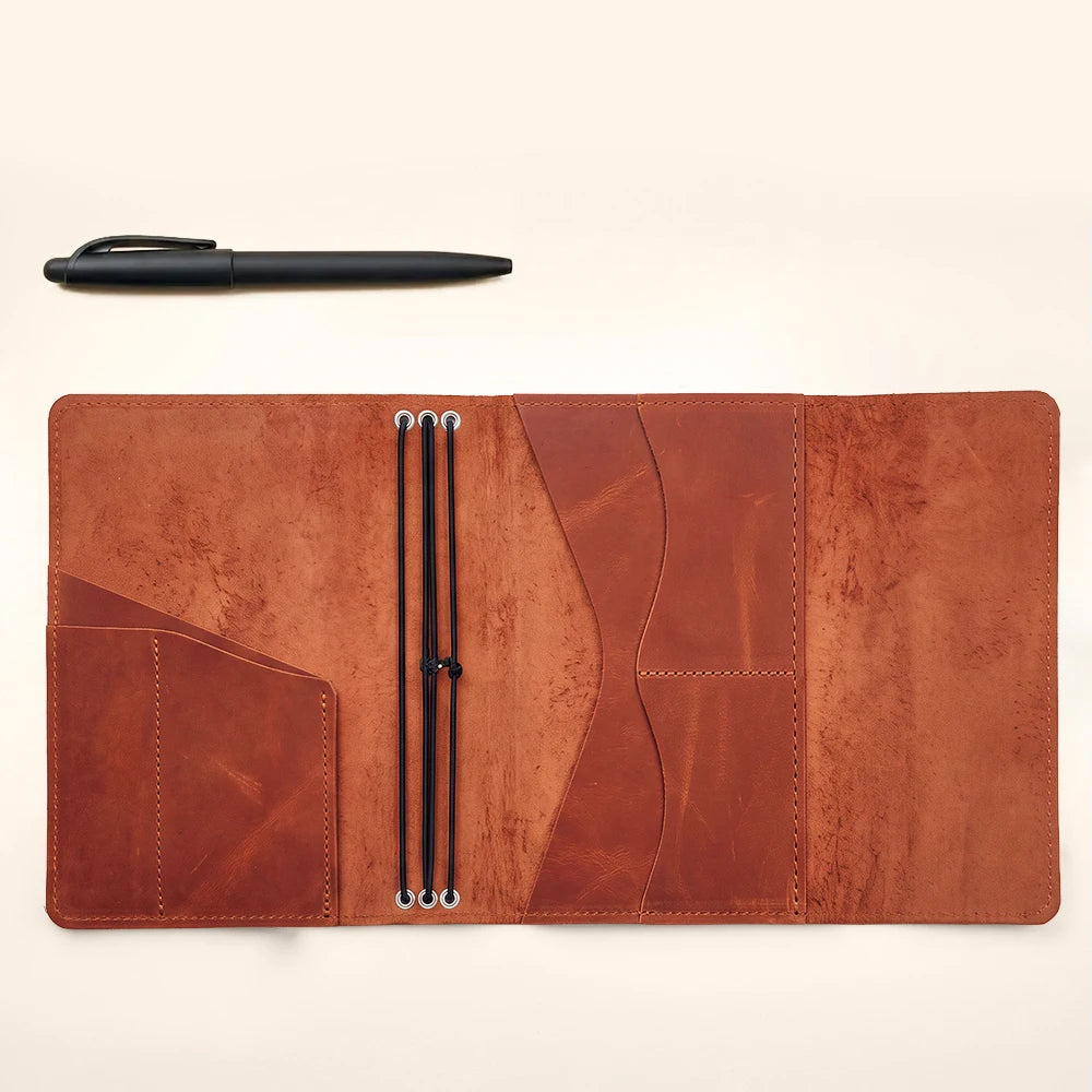 Premium leather notebook case featuring organized inside pockets and refillable elastic journal inserts.