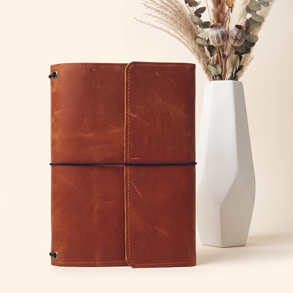 Genuine leather notebook holder with handcrafted details and three secure elastic notebook loops.