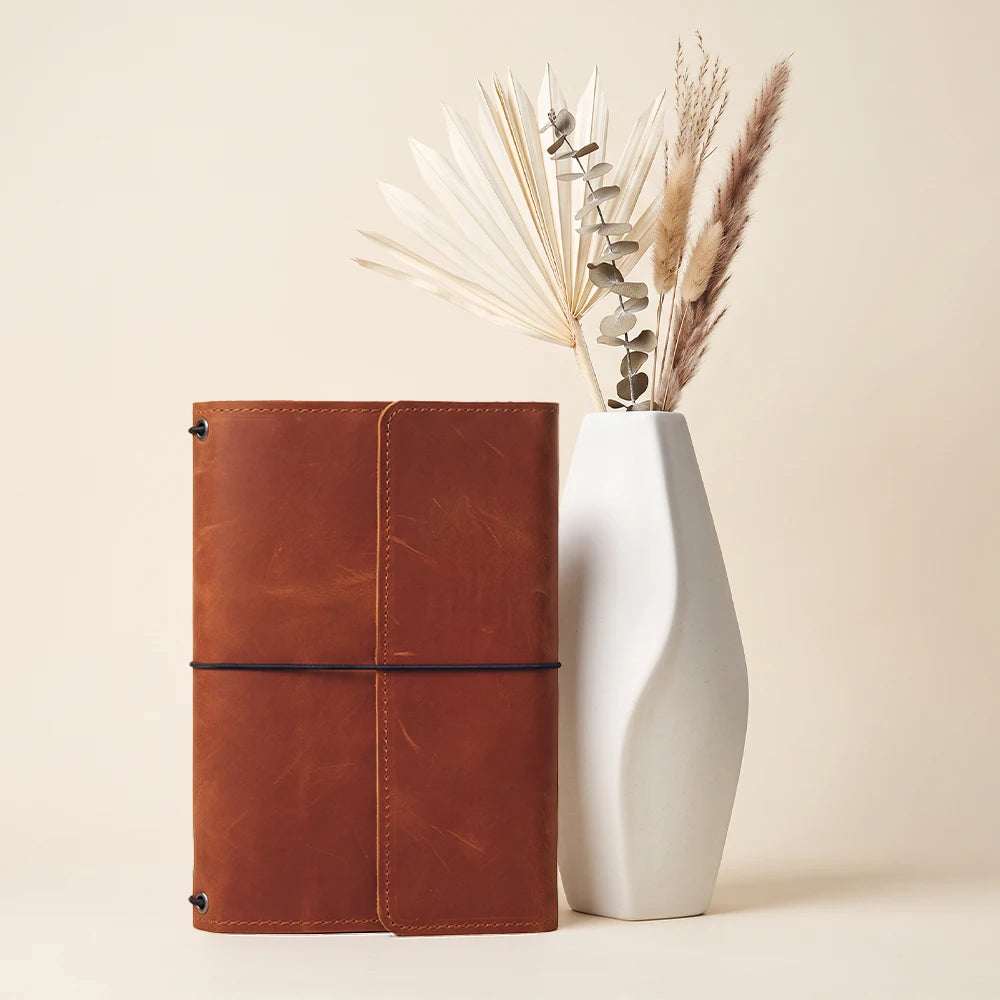 Premium leather notebook cover with handcrafted details and practical refillable journal organization.