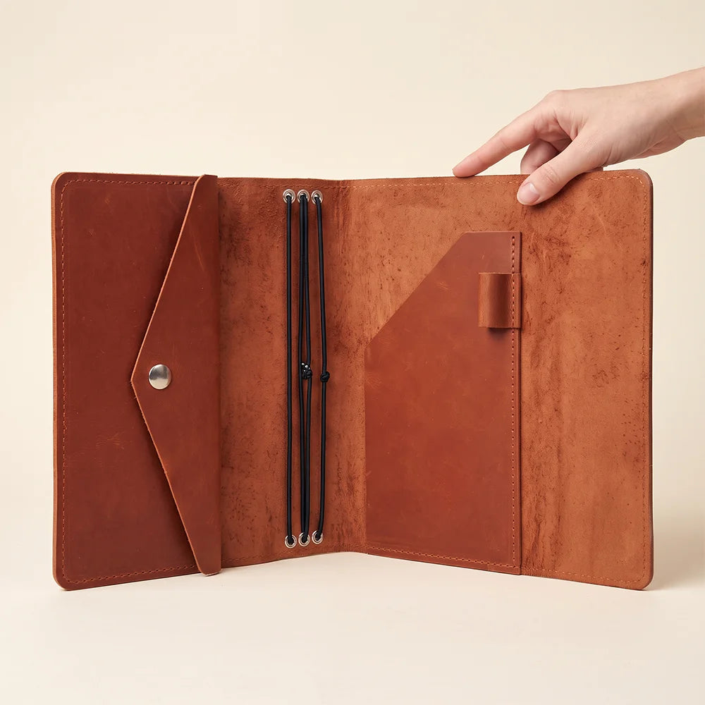 Minimalist leather notebook cover with premium finish and secure elastic insert system.