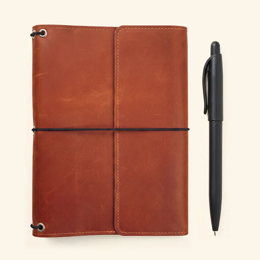 Elegant leather notebook holder with flexible elastic system and thoughtfully designed interior compartments.