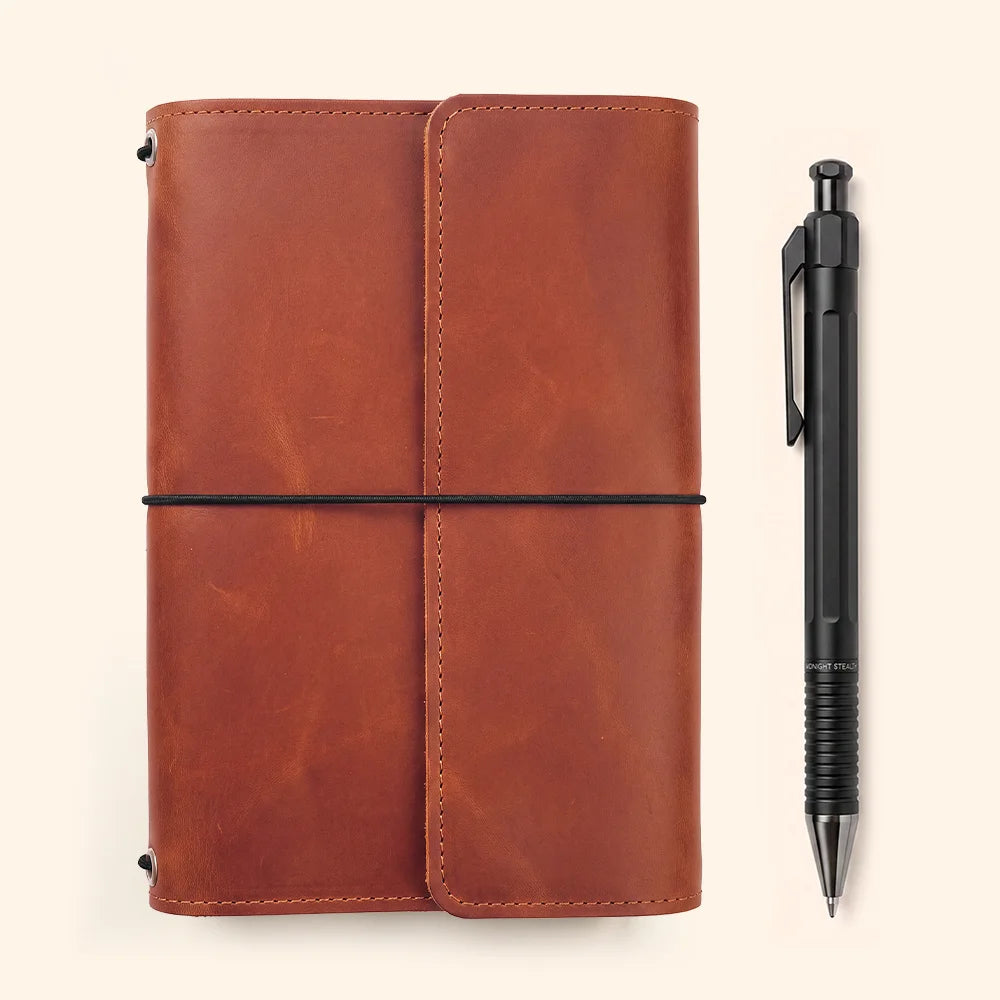 Full grain leather journal cover featuring neatly arranged storage sections and pen accommodation.