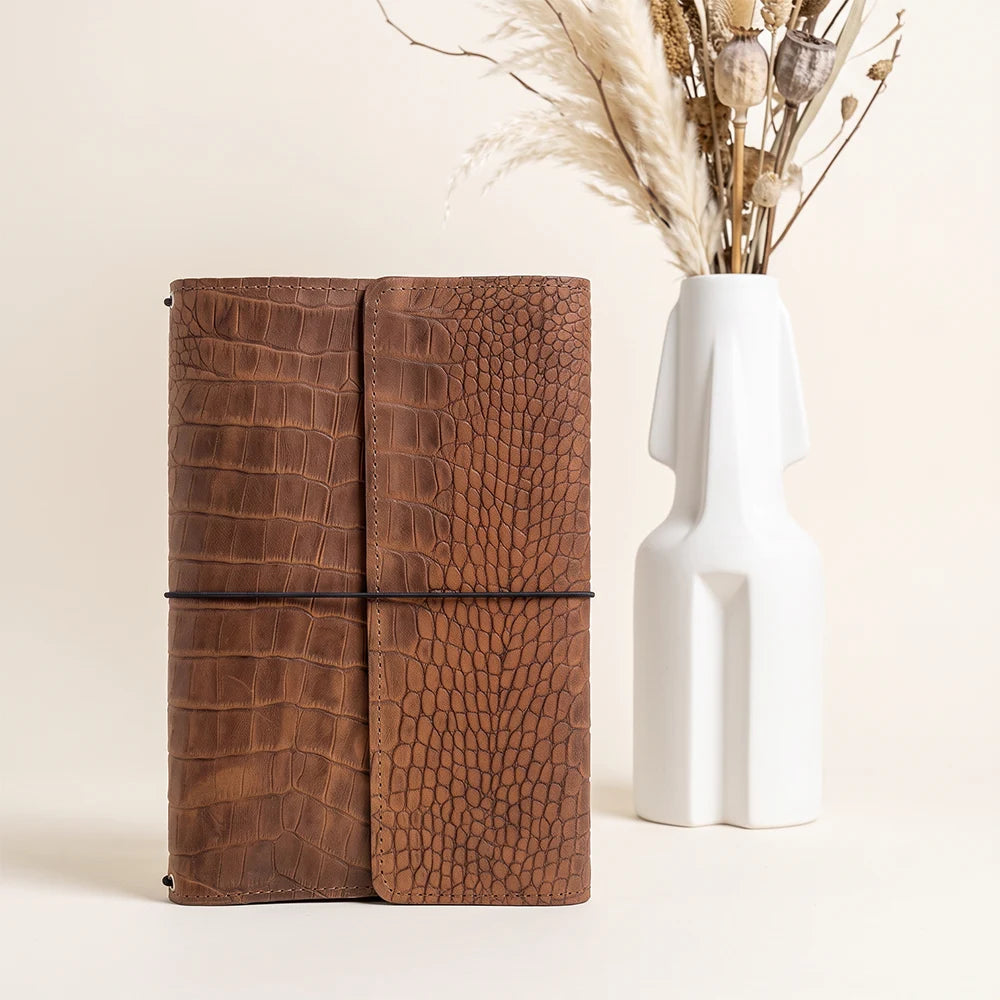 Genuine leather journal cover featuring three elastic holders and functional inside pockets.