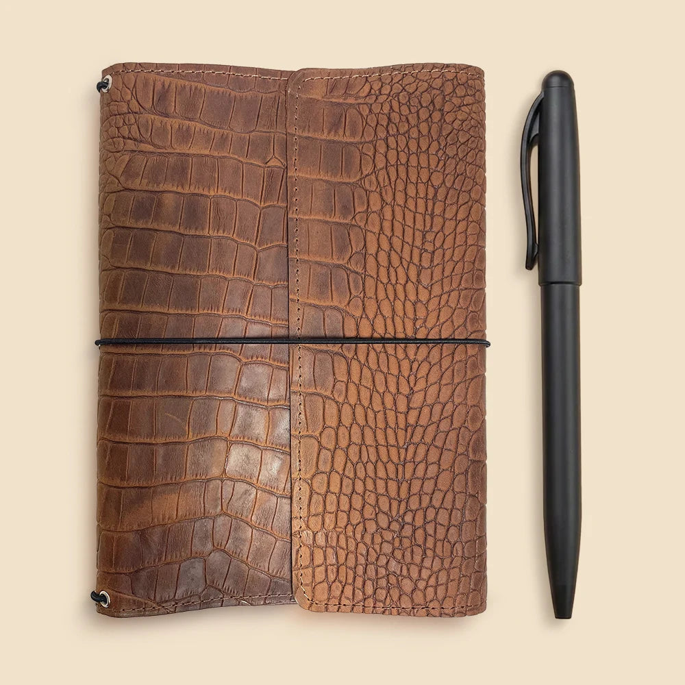 Premium leather journal cover with three elastic notebook holders and inner card pockets.
