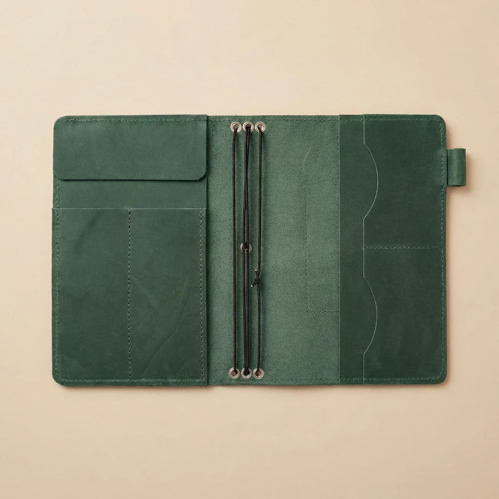 Green leather folio with strap on a beige background