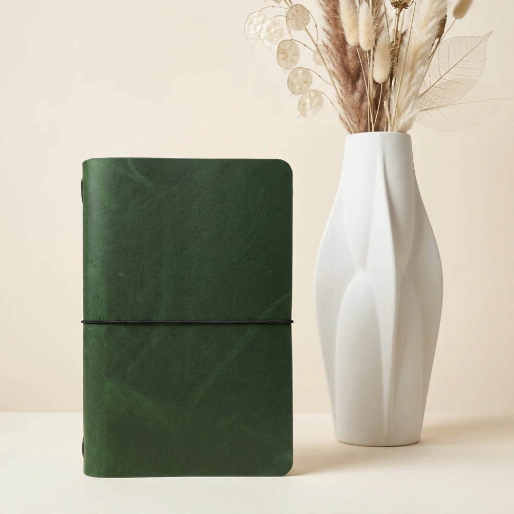 Handmade leather journal sleeve presenting a simple notebook in an elegant format.
