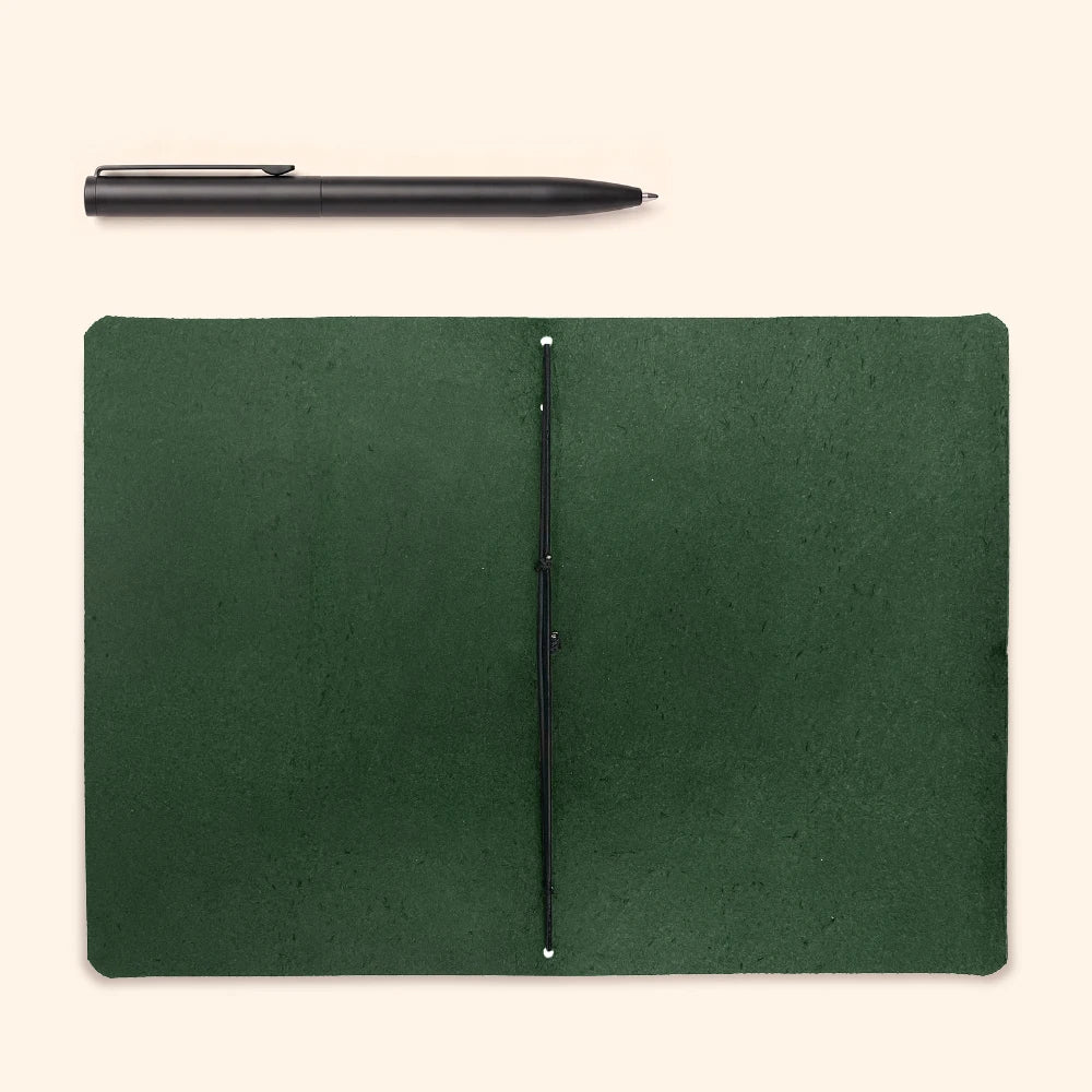 Minimal writing cover crafted from leather, holding a basic journal securely inside.