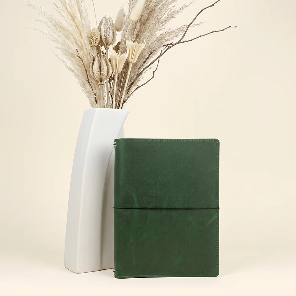 Detailed interior of a leather journal holder with pockets and refillable insert support.