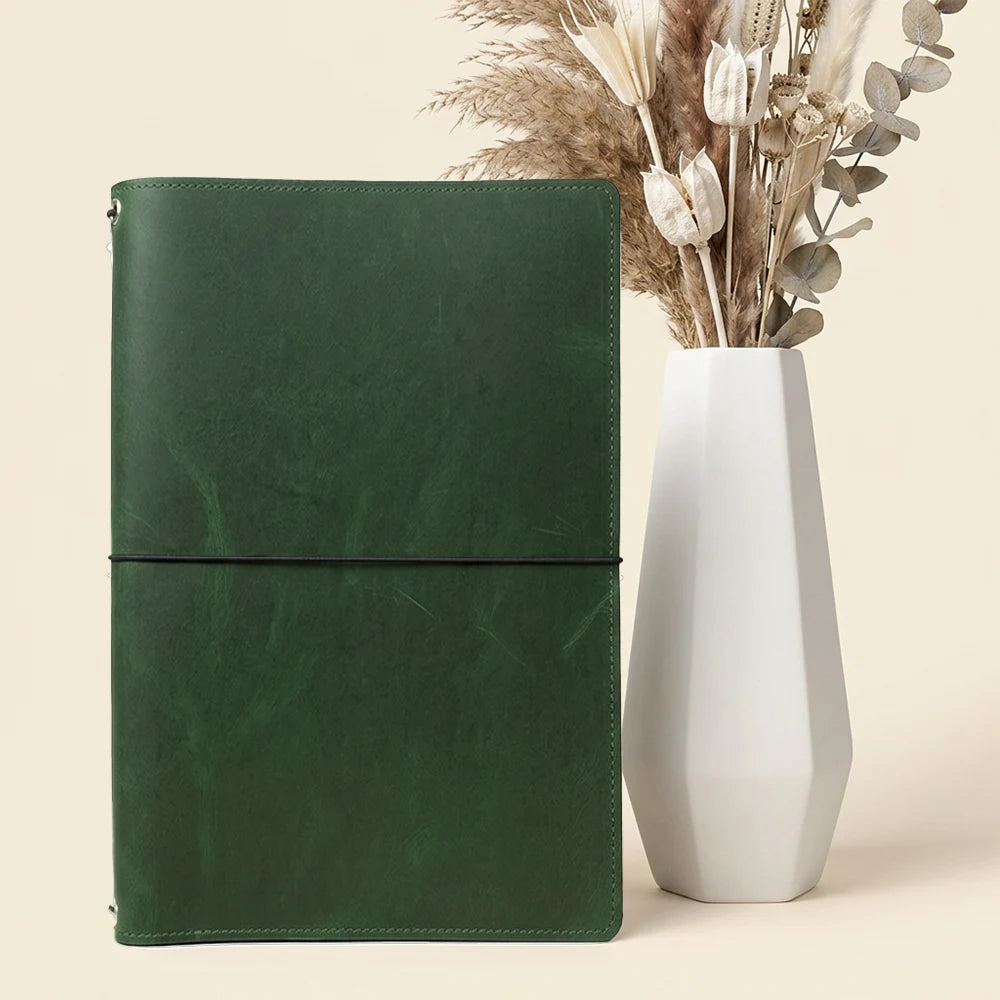 Handcrafted leather writing organizer with dedicated spaces for notebooks and loose documents.