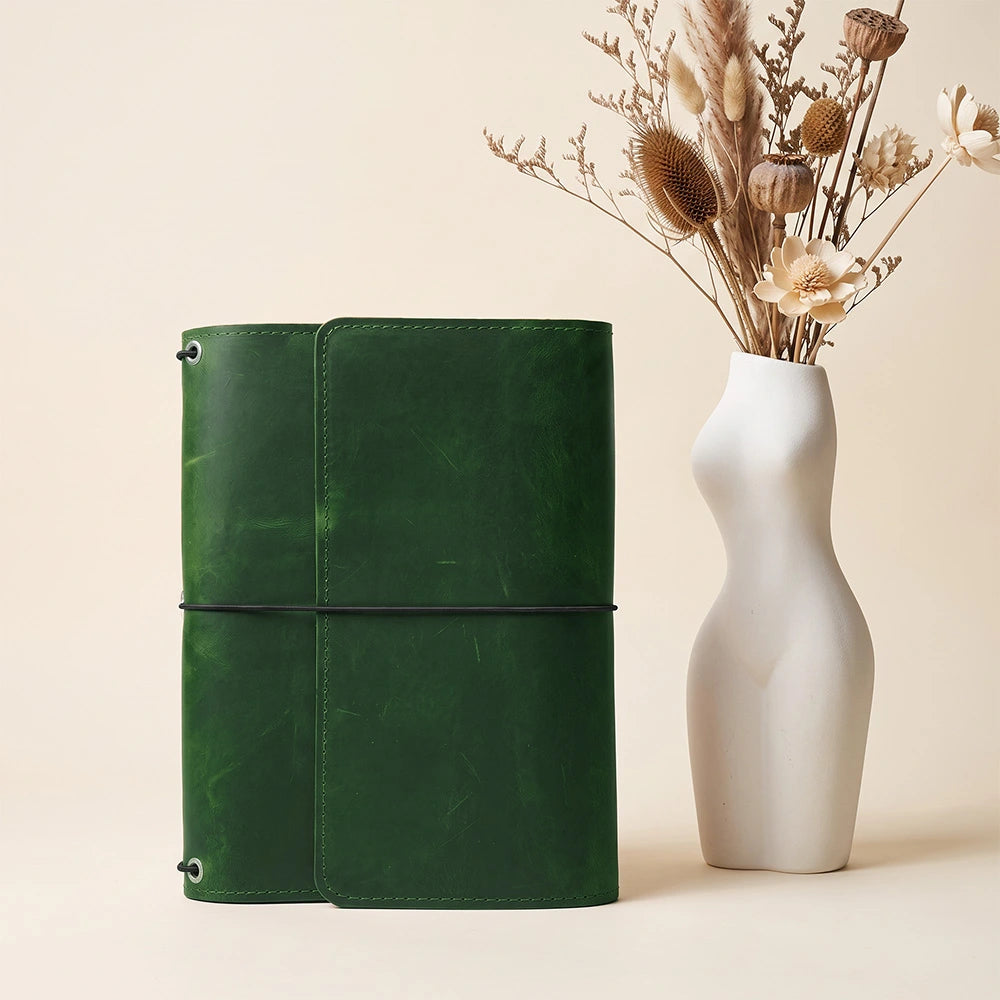 Premium leather notebook holder designed with organized pockets and dedicated writing accessory strap.