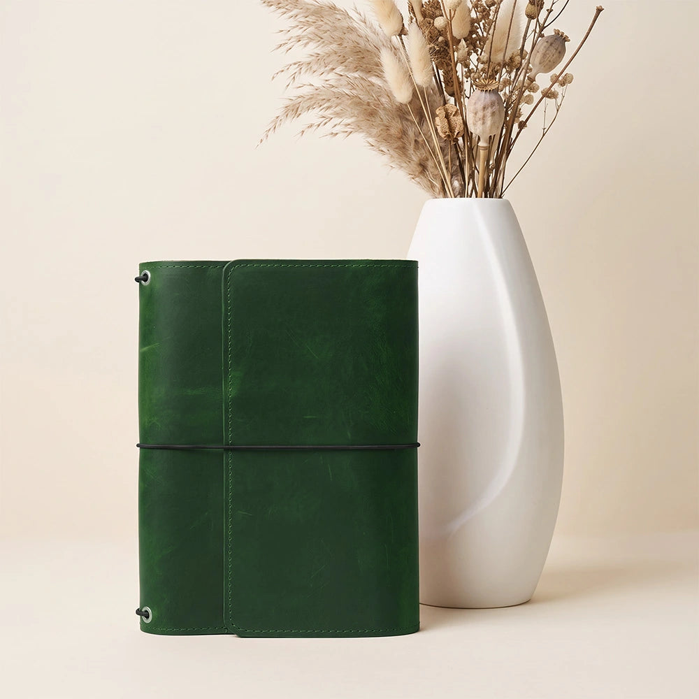 Leather notebook wrap with dedicated pen loop and interior storage for essentials.