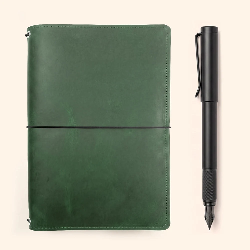 Minimalist refillable leather journal cover with three interior elastic holders.