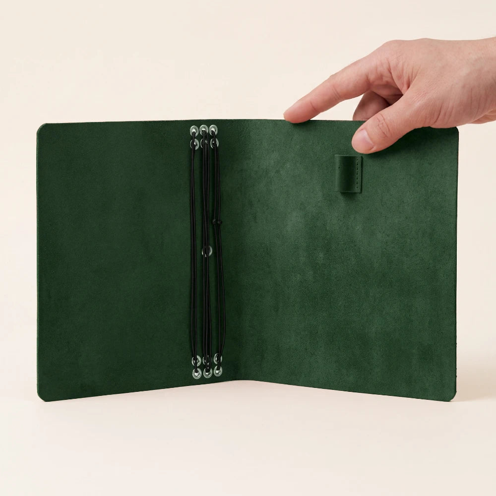 Compact genuine leather journal cover with six elastics and a practical pen holder.