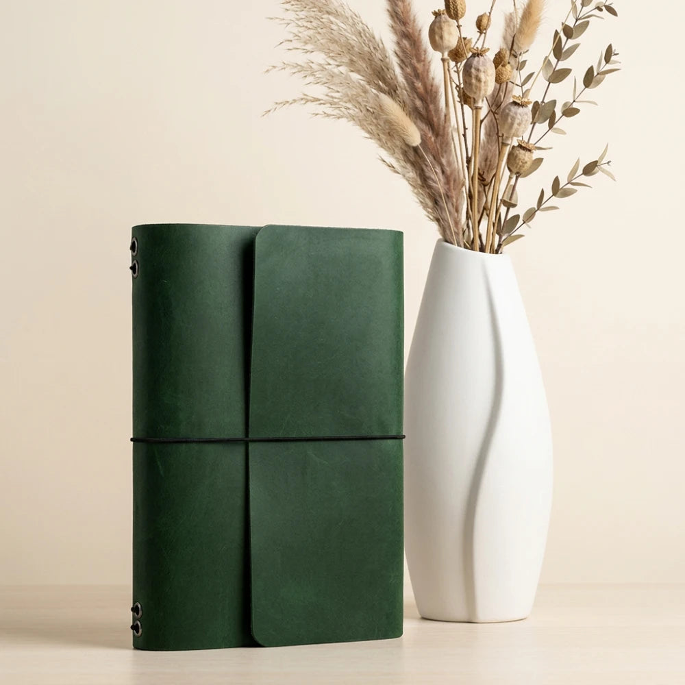 Leather travel planner cover designed with six elastic straps for multiple inserts.