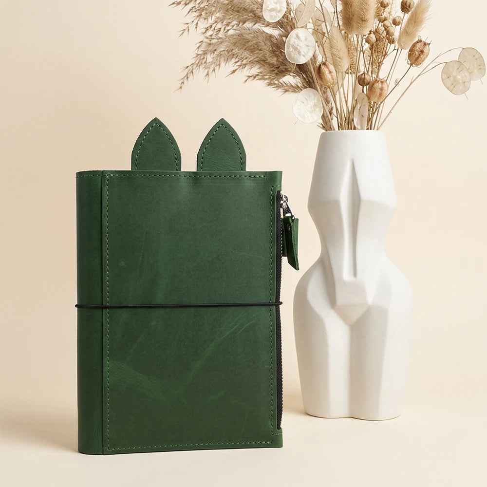 Handmade notebook holder with decorative upper accents and a secure interior zipper section.