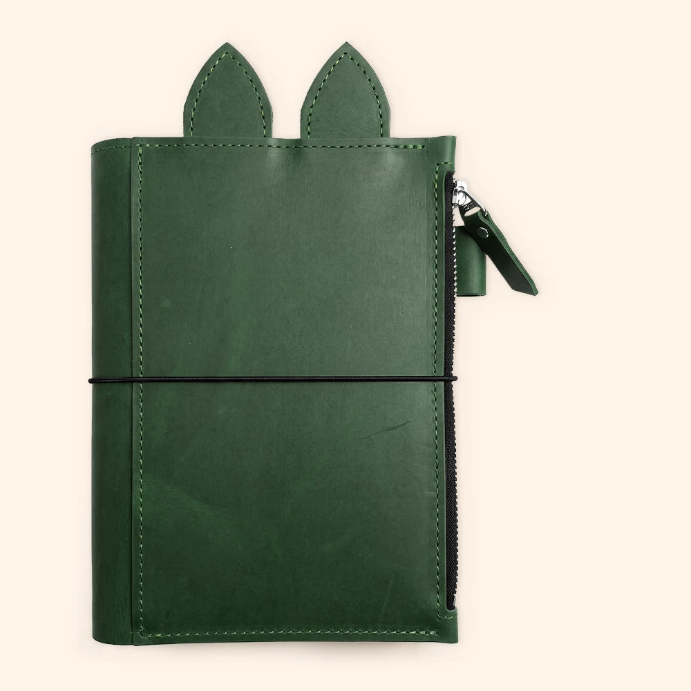 Leather journal case with triple elastic straps for securing several notebook inserts.