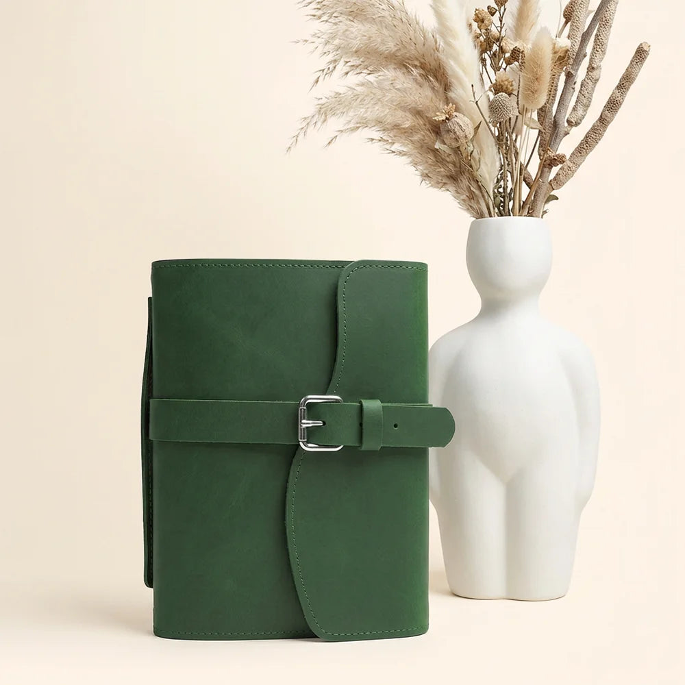 Natural hide notebook organizer with functional pockets, pen loop, bookmark ribbon, and comfortable carry handle.