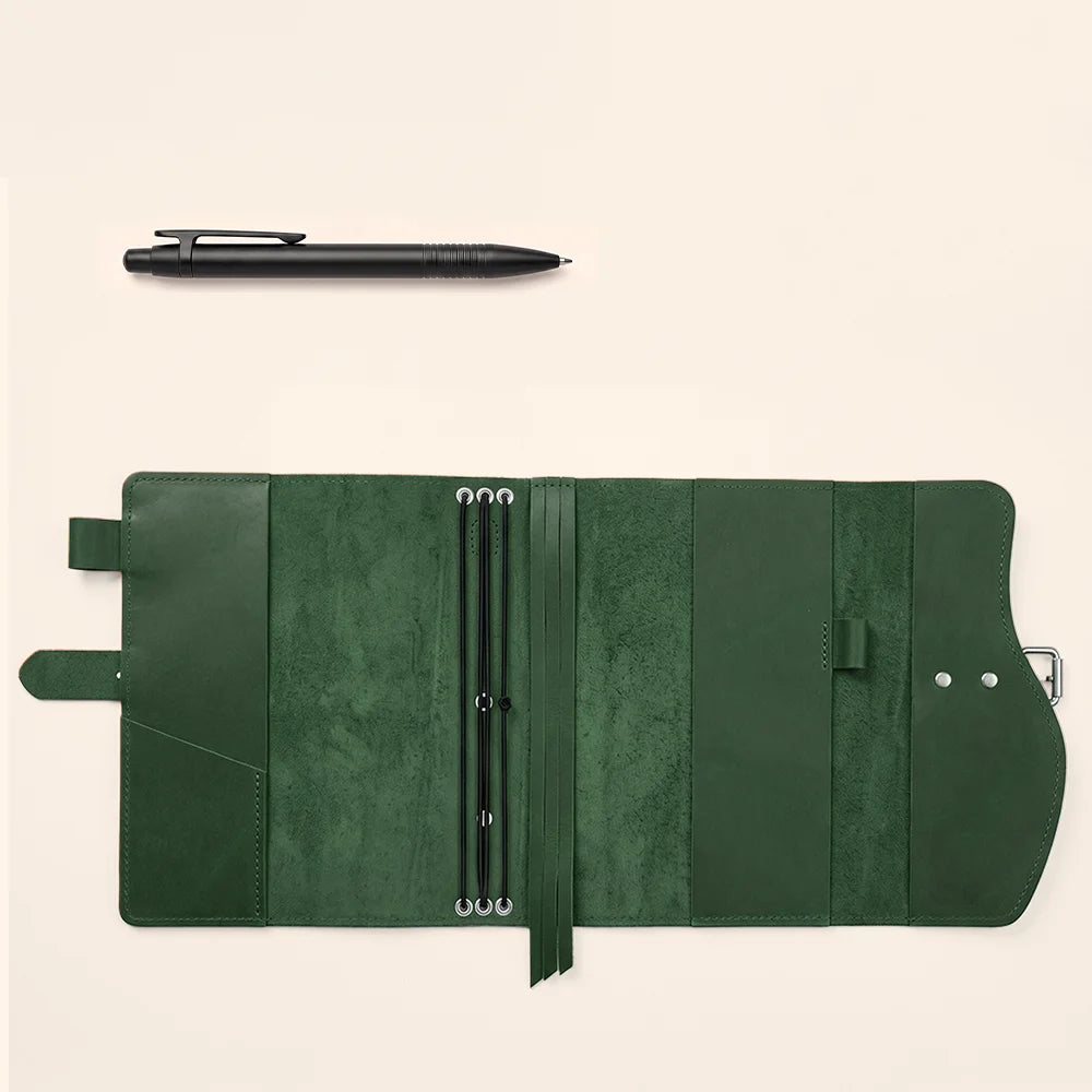 Natural leather notebook cover with functional pockets, dedicated pen loop, integrated bookmark, and sturdy carrying handle.